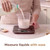 Milk being poured into a measuring jug on digital kitchen scales