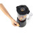 Black blender filled with mixed fruit, shown from above with a hand turning the dial