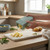 Handheld food dicer chopping potatoes into cubes on a kitchen counter