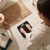 Black digital bathroom scale in use on tiled floor, showing weight reading.