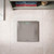 Silver bathroom digital scale with display shown on tiled floor