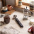 Digital kitchen thermometer on counter with coffee press, ground coffee jar and milk jug