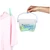 Laundry peg basket with assorted plastic pegs hanging from washing line next to pink shirt