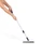 Grey floor brush with long handle shown in use