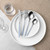 Table setting with silver cutlery and light blue handles on white plates