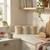 Set of three beige kitchen storage jars with wooden lids on marble worktop