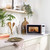 White microwave oven with open door shown from above, digital display and control panel visible