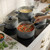 Set of grey non-stick saucepans in use on hob, ideal for cooking pasta and sauces