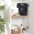 Black digital bathroom scale on shelf with towels and soap, styled in modern bathroom