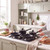 Black non-stick frying pans and saucepans set on a gas hob