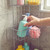 Chrome shower caddy with soap bottles, sponges and bath puff