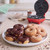 Red mini doughnut maker with chocolate and sugar-coated doughnuts