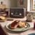 Brown four-slice toaster on kitchen worktop with toast and jam