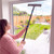 Woman cleaning patio door with long-handled window mop