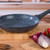 Non-stick blue speckled frying pan with black handle on kitchen counter