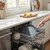 Grey non-stick frying pan placed in dishwasher, kitchen setting
