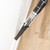 Cordless vacuum cleaner with crevice tool cleaning floor edge and skirting board