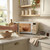 Cream microwave on kitchen counter with glass bowl inside, door being opened