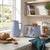 Blue kettle and toaster set on kitchen counter, bread and berries nearby