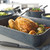 Blue speckled roasting tin with cooked chicken and vegetables