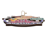 Side view of Austin, TX wooden ornament showing layered wood thickness and printed edge detail on white background.