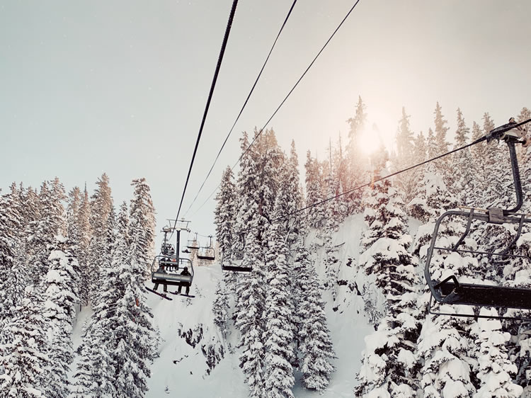 Chair lift amongst snow covered trees