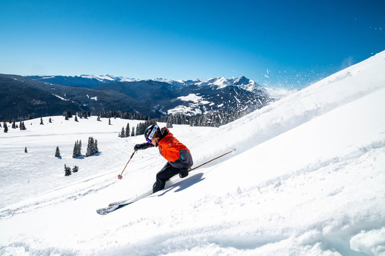 Skier turning sharply through powder snow