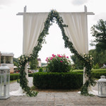 Ivory and Green Wedding Ceremony Backdrop
Sheer drapes, greenery garlands, and cream roses make this an unforgettable wedding ceremony setup. Wedding designers turn to ShopWildThings for every element—structure to styling. Ivory and Green Wedding Ceremony Backdrop
Sheer drapes, greenery garlands, and cream roses make this an unforgettable wedding ceremony setup. Wedding designers turn to ShopWildThings for every element—structure to styling.