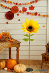 Oversized silk sunflower decoration 44 inches tall displayed at fall party with pumpkins, rustic table, and autumn garlands – perfect sunflower event prop from ShopWildThings.