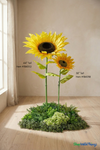 44 inch and 38 inch tall oversized artificial sunflowers with item numbers 186052 and 186038 shown for scale, large silk sunflower stems displayed in modern indoor event décor setting by ShopWildThings.