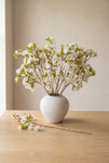 ShopWildThings artificial cherry blossom arrangement in white vase on wood table in warm minimal interior setting
