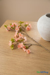 ShopWildThings artificial pink cherry blossom branch on wood table with white vase in warm minimal interior setting