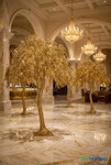 7 foot gold artificial trees installed in luxury hotel lobby setting, professional casino and wedding event decor installation by ShopWildThings