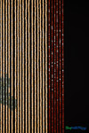 Handmade wooden bead curtain with natural tan, brown, and green beads forming dog bone design – 65 strands for doorway or wall décor.