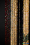 Rustic wooden bead curtain featuring red border, tan center beads, and green accents forming playful dog bone pattern.