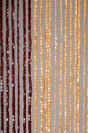 Handmade wooden bead curtain with natural tan, brown, and green beads forming dog bone design – 65 strands for doorway or wall décor.