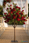 Artificial red rose tree used as outdoor wedding aisle décor centerpiece with elegant floral arch backdrop
