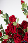 Red artificial rose flower close up showing layered fabric petals and realistic floral craftsmanship