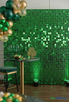 Emerald Green Shimmer Sequin Wall backdrop used for St. Patrick’s Day event décor with gold and green balloons, cocktail table, and clover décor – ShopWildThings