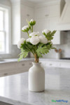 Real feel white ranunculus arranged in a small ceramic vase on a kitchen countertop – elegant artificial floral decor from ShopWildThings.com