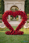 Heart shaped red rose floral arch wedding ceremony backdrop luxury outdoor venue crimson silk roses arch ShopWildThings.com