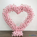 Pink silk rose heart shaped arch wedding backdrop symmetrical floral installation ShopWildThings.com