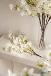 40" Faux Cream White Cherry Blossom Branch from ShopWildThings.com showing cream white blossoms, green leaves, and realistic brown stems