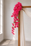 41" Beauty Pink Cascading "Spring Blossom" Spray – Extra-Full Silk Floral Waterfall from ShopWildThings.com styled on a simple wooden wedding arch with white draping, natural window light, and cascading pink floral branches for ceremony decor.