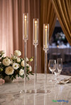 Timeless Luminosity: The "Solange" 3-Stem Acrylic Candelabra styled with LED taper candles on a marble event table with elegant floral decor - ShopWildThings.com