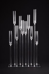 Angled view of the Isolde 10-stem acrylic hurricane candelabra featuring crystal-clear candle sleeves and customizable height arrangement for luxury event decor.