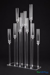 Isolde 10-stem staggered acrylic hurricane candelabra centerpiece with clear glass-look acrylic cylinders and customizable stem heights on a rectangular base for wedding and event table decor.