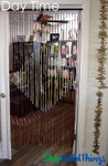 Bamboo Beaded Curtain in a Doorway with Lights on behind it ShopWildThings.com