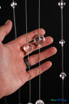 Close-up of two clear acrylic sphere sizes on steel wire from Clear Round Spheres Acrylic Ball Beaded Curtain – ShopWildThings.com