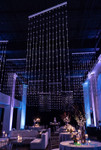 Clear Round Spheres Acrylic Ball Beaded Curtain 3' x 6' hanging in a blue-lit event venue for a sparkling ceiling installation – ShopWildThings.com